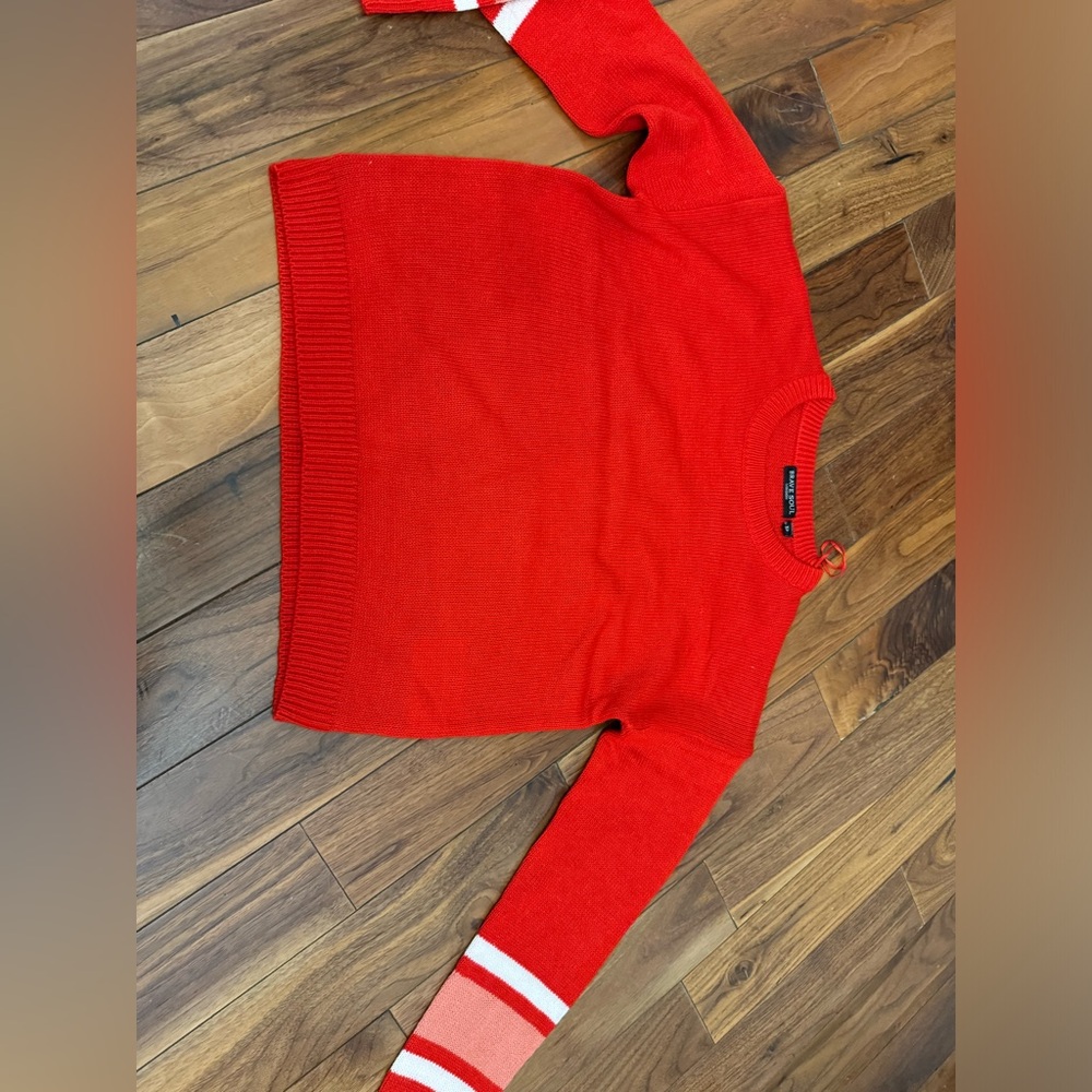 Red Sweater with white sleeve detail.
Size XS
Never worn
